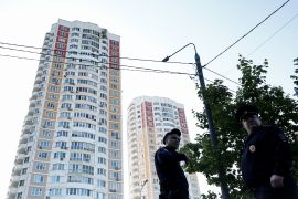 Russian law enforcement officers stand guard near a damaged multi-storey apartment block following a reported drone attack in Moscow, Russia [Maxim Shemetov/Reuters]