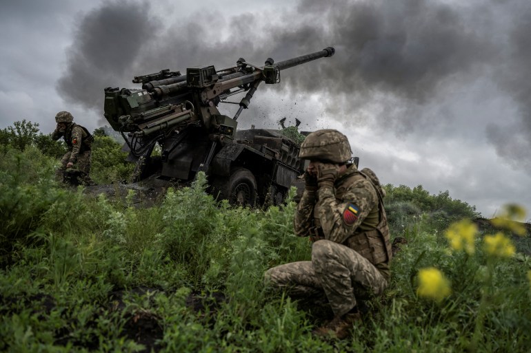 Ukrainian service members of the 55th Separate Artillery Brigade fire a Caesar self-propelled howitzer