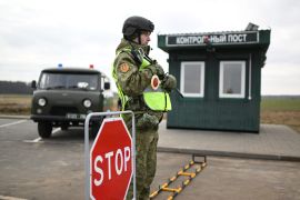 Belarusian border guards check drivers and vehicles entering the border zone near the frontier with Ukraine near the settlement of Divin in the Brest region on February 15, 2023. (Photo by Natalia KOLESNIKOVA / AFP)