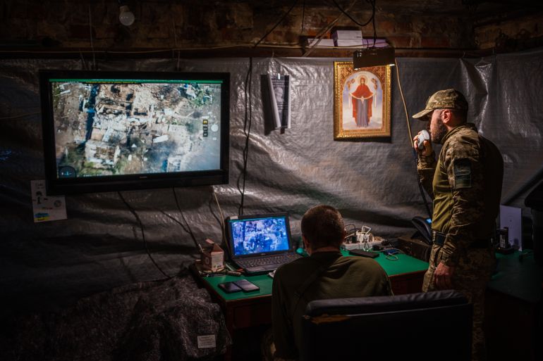Ukrainian servicemen of the State Border Guard Service watch drone feeds from an underground bomb shelter near the frontline city of Bakhmut, Donetsk region on May 3, 2023, amid the Russian invasion of Ukraine. [Dimitar Dilkoff/AFP]