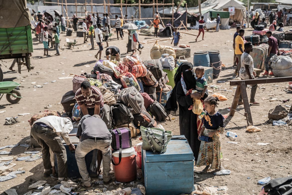 Refugees who crossed from Sudan to Ethiopia put their belongings on the ground for a security check in Metema