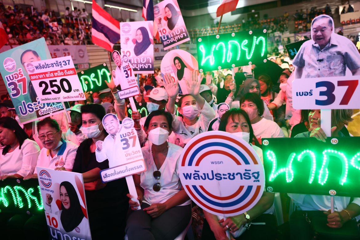Supporters hold up placards and LED lights at the Palang Pracharath Party's last rally