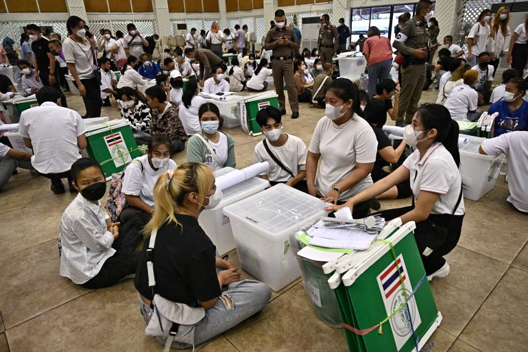 Election Commission volunteers inspect ballots and voting materials for distribution to polling booths in Bangkok on May 13, 2023, on the eve of the Thailand General election.
