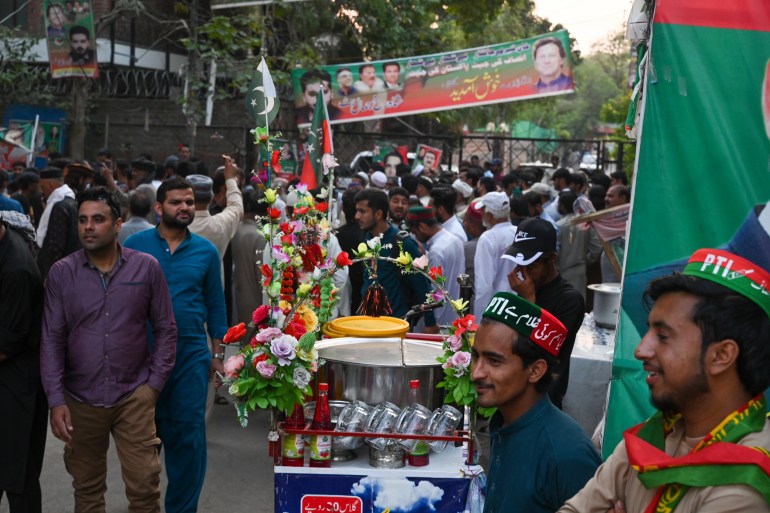 Tehreek-e-Insaf (PTI) party activists and supporters gather outside Pakistan's former Prime Minister Imran Khan's residence to listen his speech, in Zaman Park in Lahore on May 13, 2023
