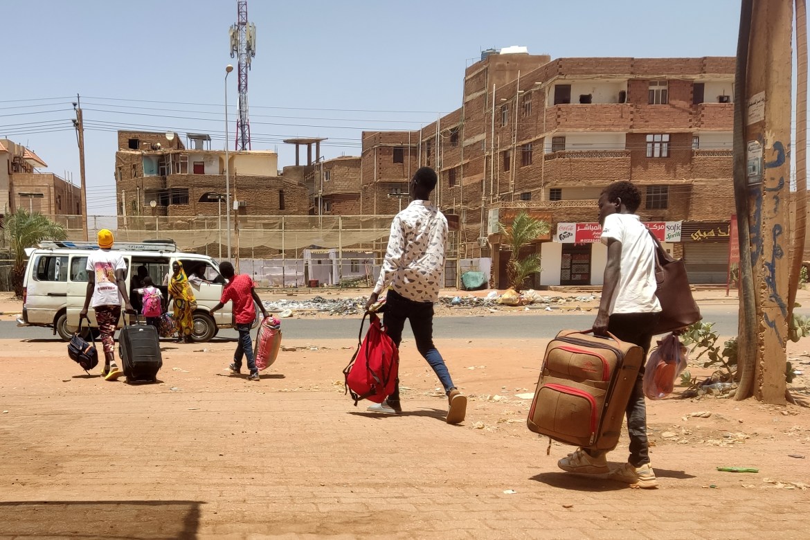 People board a mini-bus as they evacuate southern Khartoum