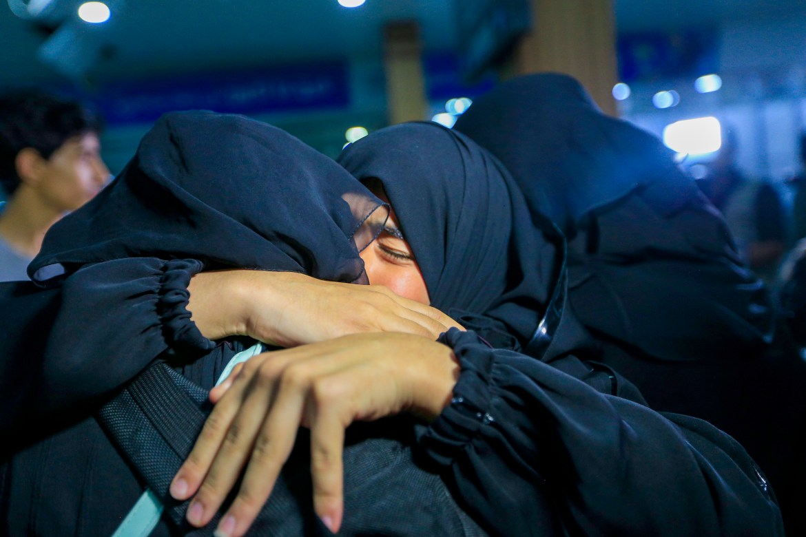 A woman embraces her relative upon arrival at the Sanaa International Airport in Sanna