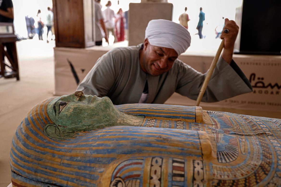 Mostafa Abdo Sadek, the overseer of diggers,observes a newly discovered sarcophagus in the Saqqara necropolis