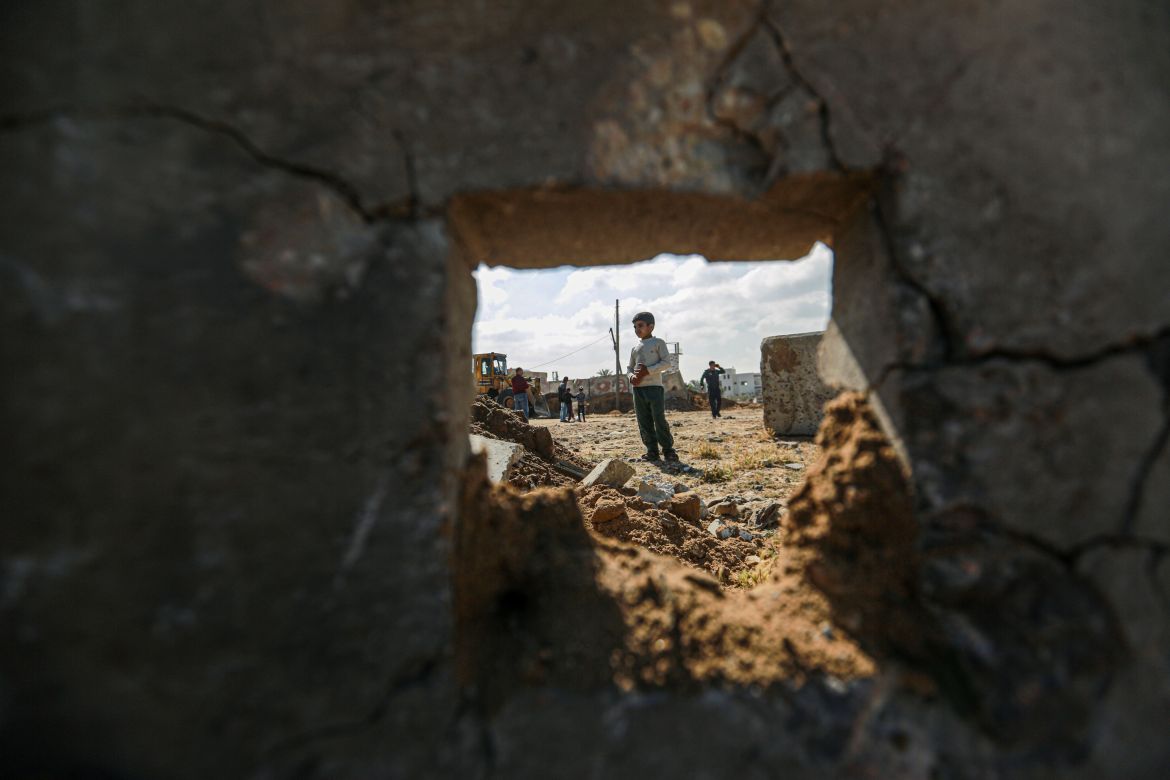 A child inspects the site of the bombing in Deir al-Balah, central Gaza Strip_-1683179216