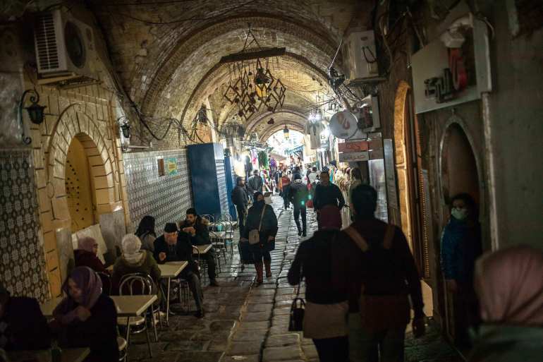 People walk in the old Medina of Tunis