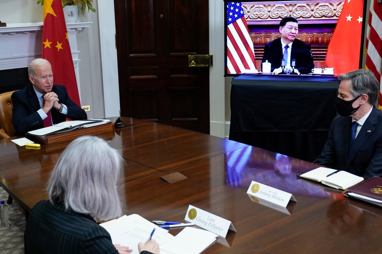 President Joe Biden meets virtually with Chinese President Xi Jinping from the Roosevelt Room of the White House in Washington, DC, Monday, Nov. 15, 2021, as Secretary of State Antony Blinken listens.