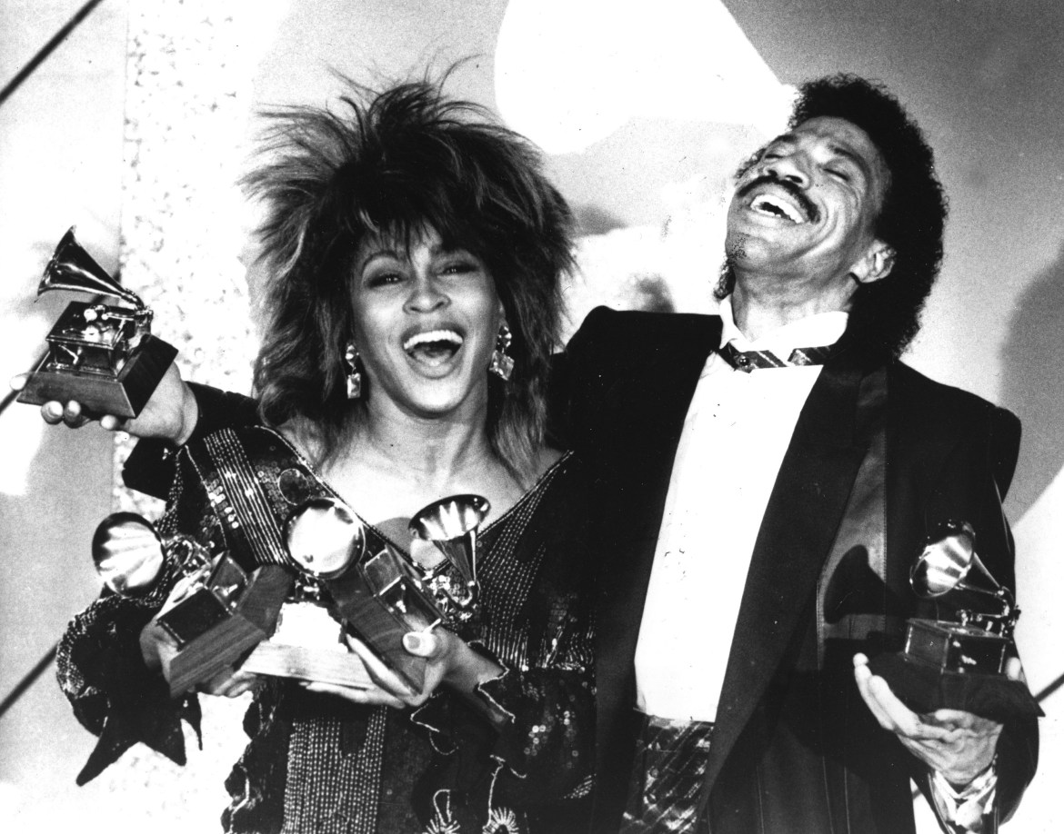 Tina Turner, left, and Lionel Richie pose with a total of five awards between them, at the Grammy Awards