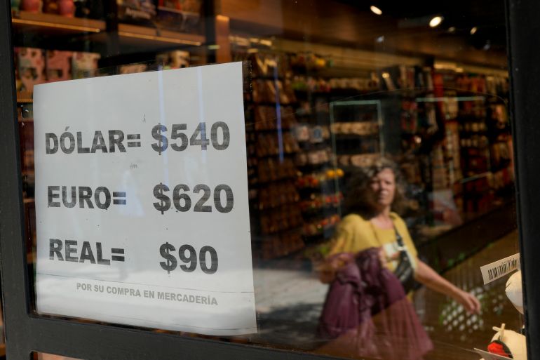 A shop displays on a sheet of paper unofficial currency exchange rates in Buenos Aires, Argentina