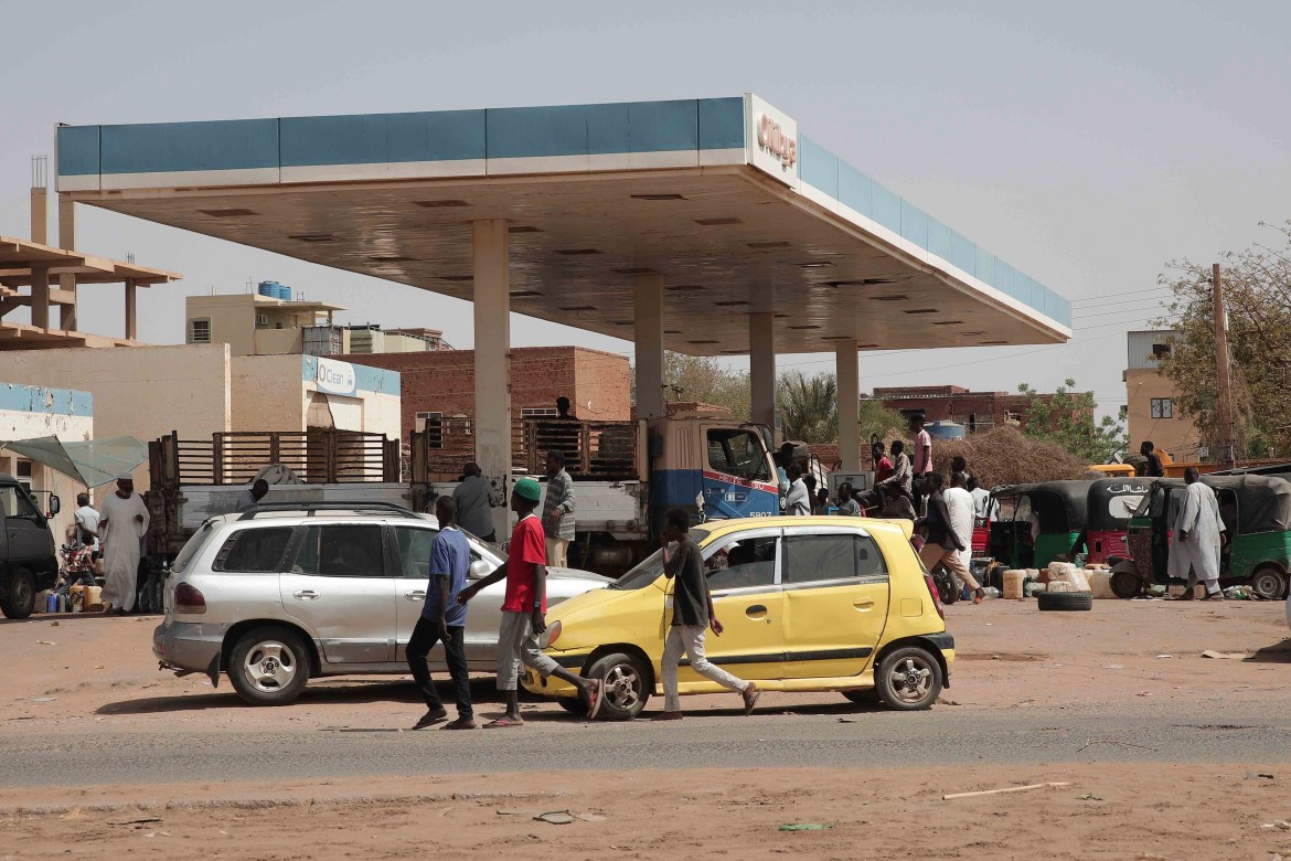 People line up at a gasoline station in Khartoum, Sudan
