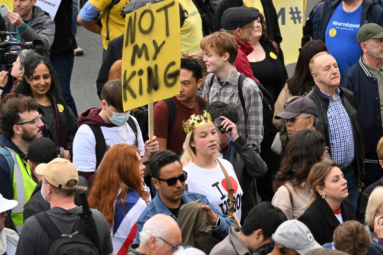 A protester holds up a placard reading 'Not My King' in Trafalgar Square in central London