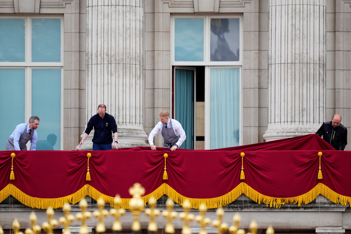 Workers prepare the balcony of Buckingham Palace ahead of King Charles III's coronation ceremony in London.