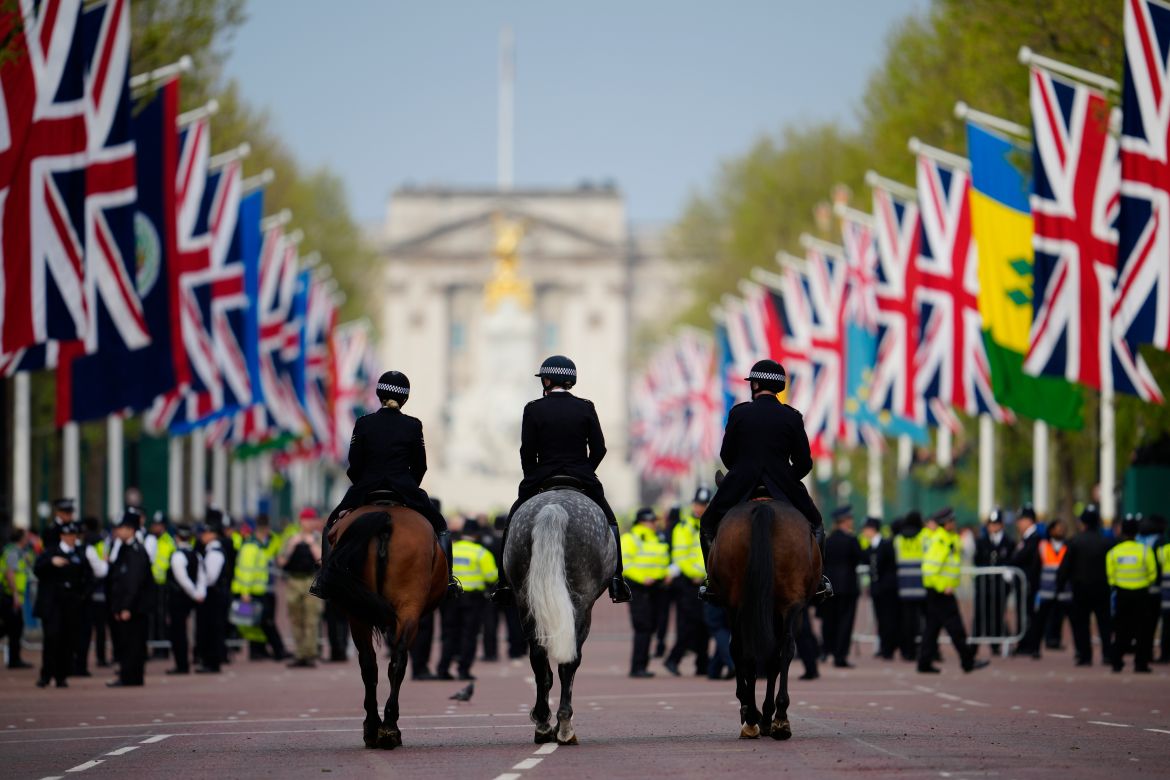 Police ride on horseback at the Mall before the coronation of Britain's King Charles III in London.