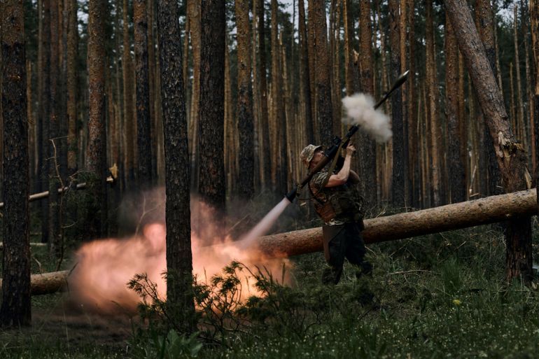 A Ukrainian soldier fires an RPG toward Russian positions at the frontline near Kremenna in the Luhansk region, Ukraine, Tuesday, May 9, 2023. (AP Photo/LIBKOS)