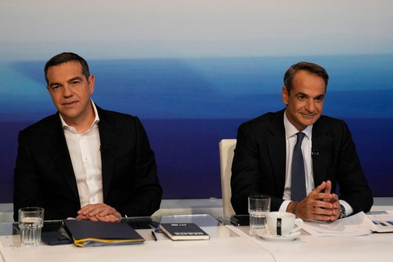 Greek Prime Minister and New Democracy leader Kyriakos Mitsotakis, right, and the leader of the main opposition Syriza party, Alexis Tsipras