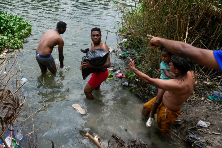 Migrants crossing the river
