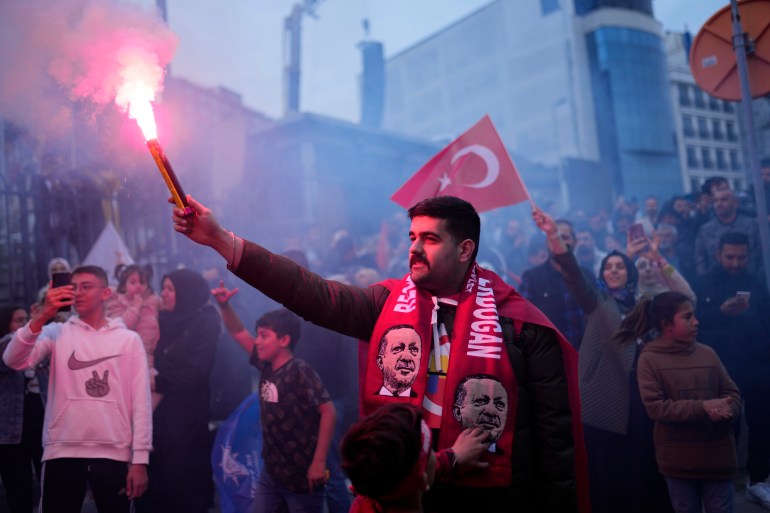 Supporters of President Recep Tayyip Erdogan cheer outside the AK Party headquarters in Istanbul