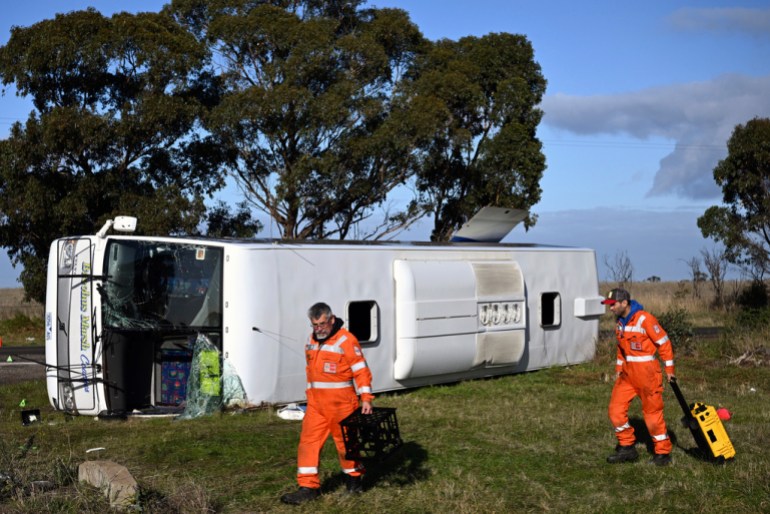 Investigators work at the scene of a bus crash near in Melbourne, Wednesday, May 17, 2023. Seven children remain hospitalized with serious injuries after a truck struck a school bus Tuesday carrying as many as 45 students on the outskirts of Melbourne in southeastern Australia. (Joel Carrett/AAP Image via AP)