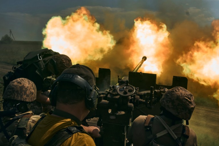Ukrainian soldiers fire a cannon