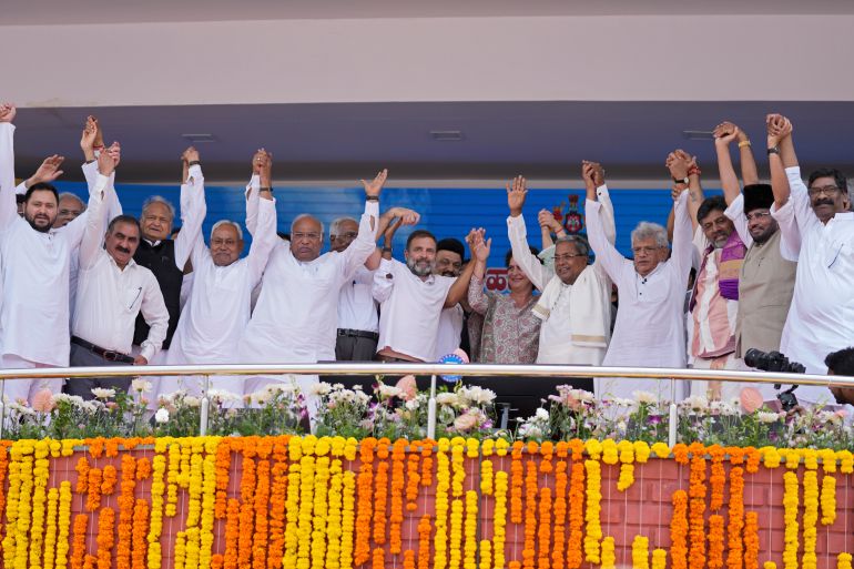 Leaders of different political parties raise their hands after the swearing-in ceremony of Congress party leader Siddaramaiah, fifth right, as Chief Minister of Karnataka in Bengaluru, India, Saturday, May 20, 2023. India's main opposition Congress party wrested control of the crucial southern Karnataka state from Prime Minister Narendra Modi's Hindu nationalist party last week that boosted its prospects ahead of national elections due next year. (AP Photo/Aijaz Rahi)
