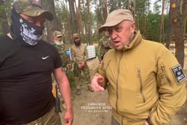 In this handout image taken from a video released by Prigozhin Press Service on Friday, May 26, 2023, head of Wagner Group military company Yevgeny Prigozhin, right, visits a rear camp of a Wagner unit at an undisclosed location. (Prigozhin Press Service via AP)