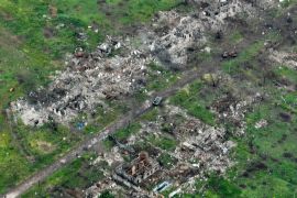 An aerial view of damaged private houses, shell and rocket craters in the suburbs of Donetsk, the site of fierce battles with the Russian forces, Ukraine, Friday, May 26, 2023. (AP Photo/Efrem Lukatsky