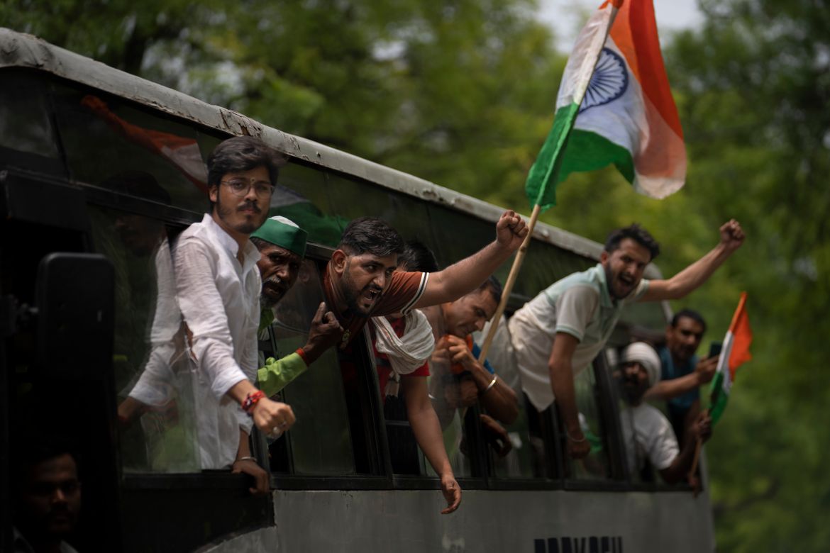 Supporters of India's top female wrestlers shout slogans from a bus after they were detained