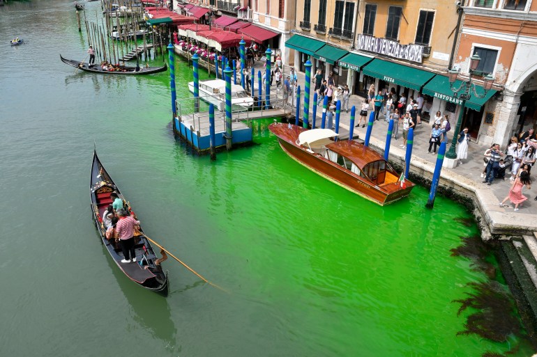 A gondola navigates along Venice's historical Grand Canal