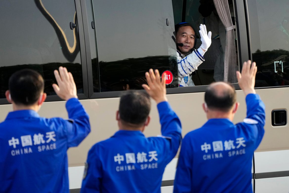 Jing Haipeng, mission commander for the Shenzhou-16 mission waves from a vehicle as he prepare to board for liftoff