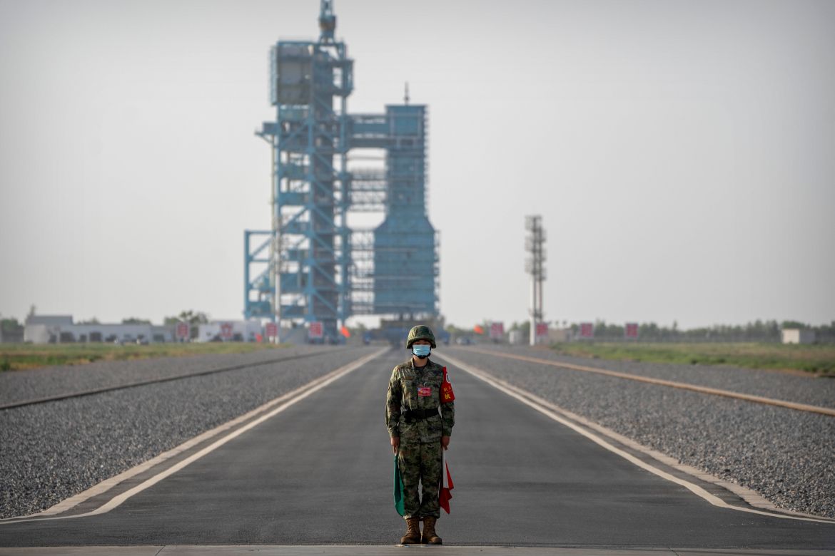 A security officer stands guard before the liftoff