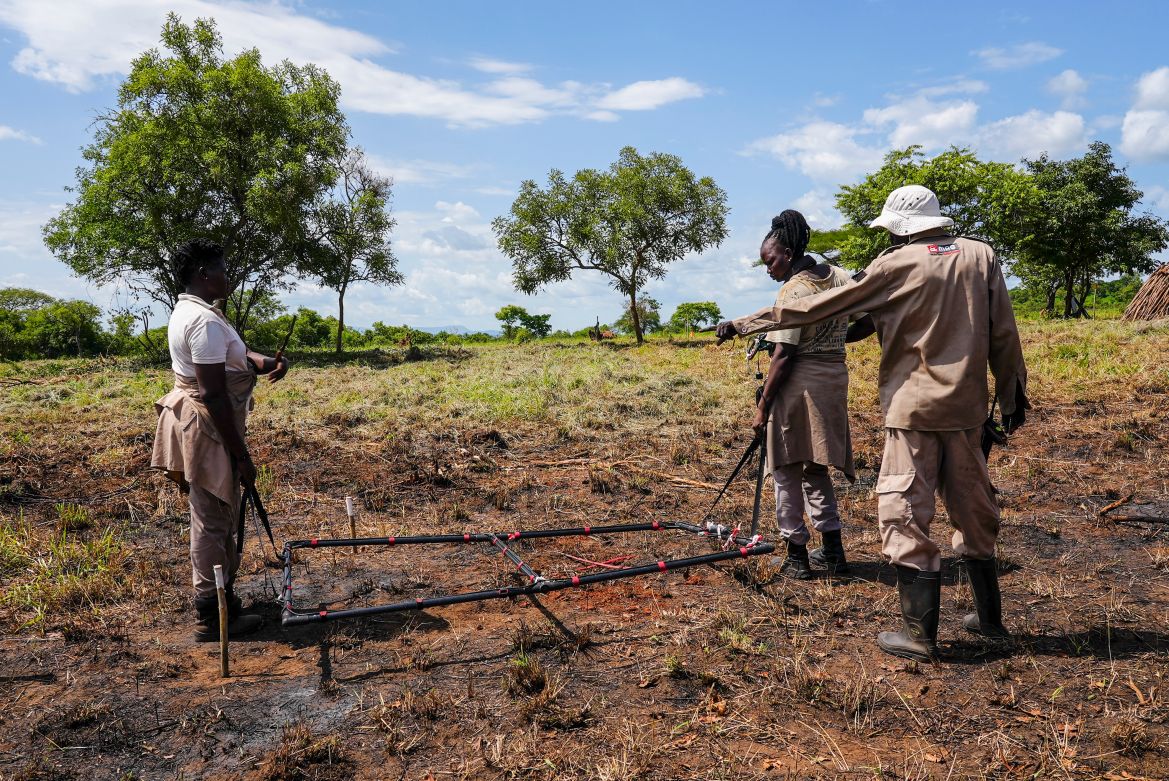 Deminers from the Mines Advisory Group (MAG) do clearance at a site containing cluster munitions in Ayii, Eastern Equatoria state