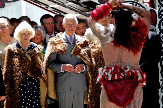 Charles and Camilla on a visit to New Zealand in 2015. They are wearing Maori capes and watching a traditional Maori welcome.