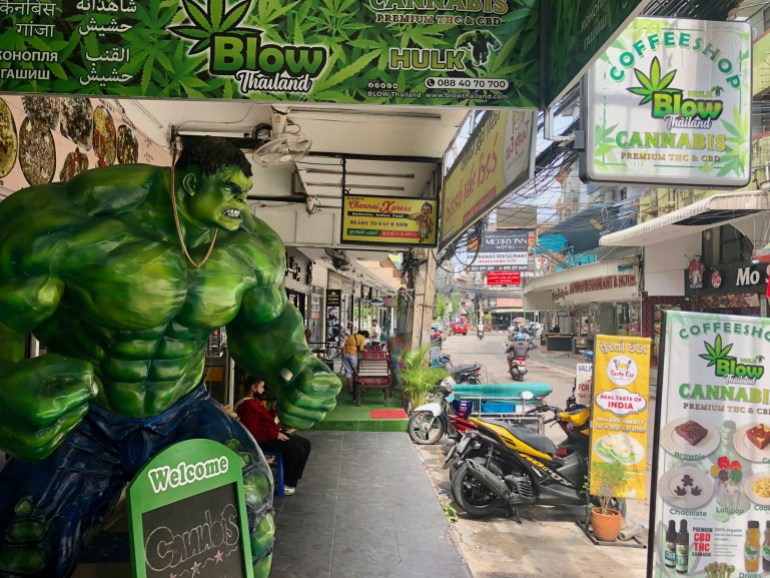 Cannabis shop advertising on a street in Thailand.