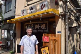 Ryuichi Ueki, like many Japanese small business owners, only accepts cash at his ramen restaurant [John Power/Al Jazeera]