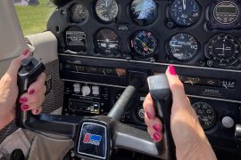 A photo of someone's hands holding the plane steering wheel.