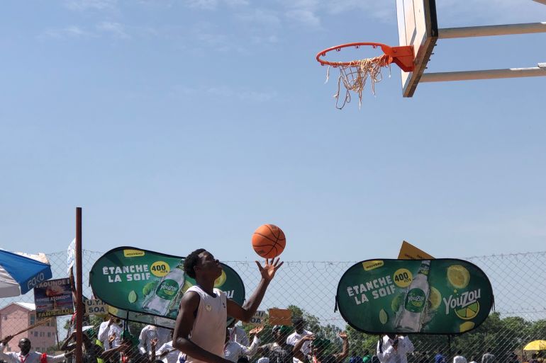 A basketball player about to take a shot underneath the hoop