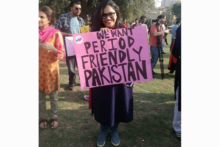 A photo of someone holding a poster with the words "We want period friendly Pakistan".