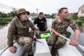 Ukrainian volunteers search for stranded animals in a flooded area of Kherson, Ukraine, on June 7, 2023 [Mykola Tymchenko/EPA]