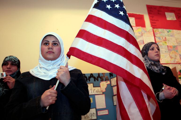 A young Muslim American female student holds the U.S. flag during a 'Children of the World' student pageant at the Islamic Center of America in Dearborn, Michigan, March 26, 2010. A growing school of thought among counterterrorism specialists, and within the administration of U.S. President Barack Obama, argues that law enforcement should engage more deeply with the Muslim community. Their case has been bolstered by encouraging examples of outreach programs. Picture taken March 26. To match SPECIAL REPORT USA-SECURITY/HOMEGROWN REUTERS/Rebecca Cook (UNITED STATES - Tags: RELIGION POLITICS)
