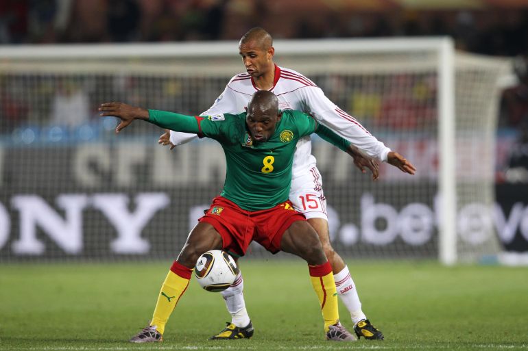 Cameroon's Geremi holds off Denmark's Simon Poulsen