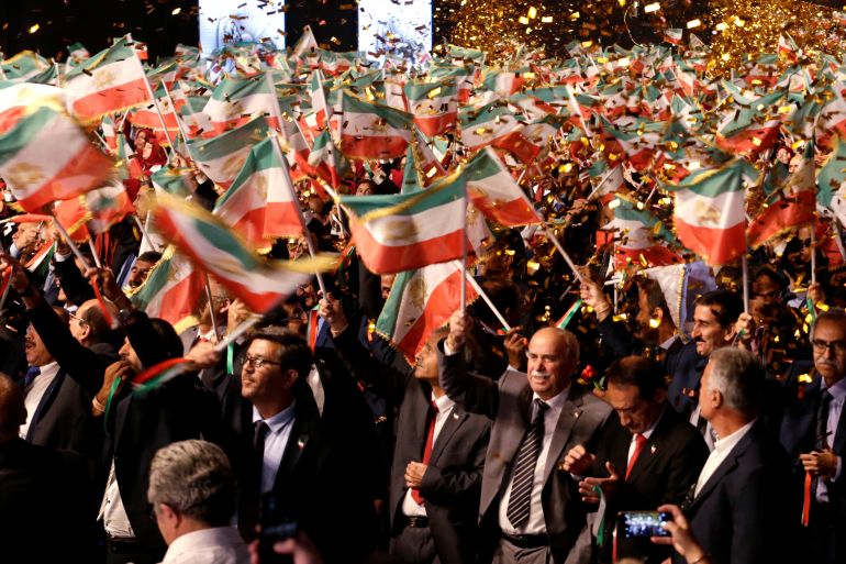 People wave flags during at an event