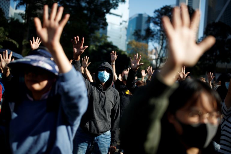 Hong Kong protesters holding their hands up and singing Glory to Hong Kong during the 2019 rallies.