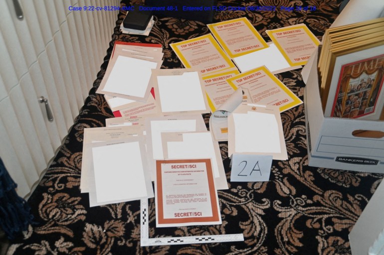 Some of the documents on the floor after being found in a container at Mar a Lago. The photo has been redacted.