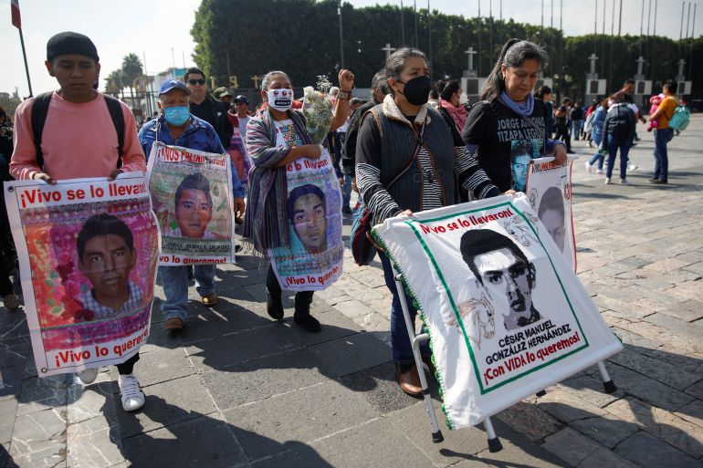 People march through the streets with poster-sized images of their missing loved ones.