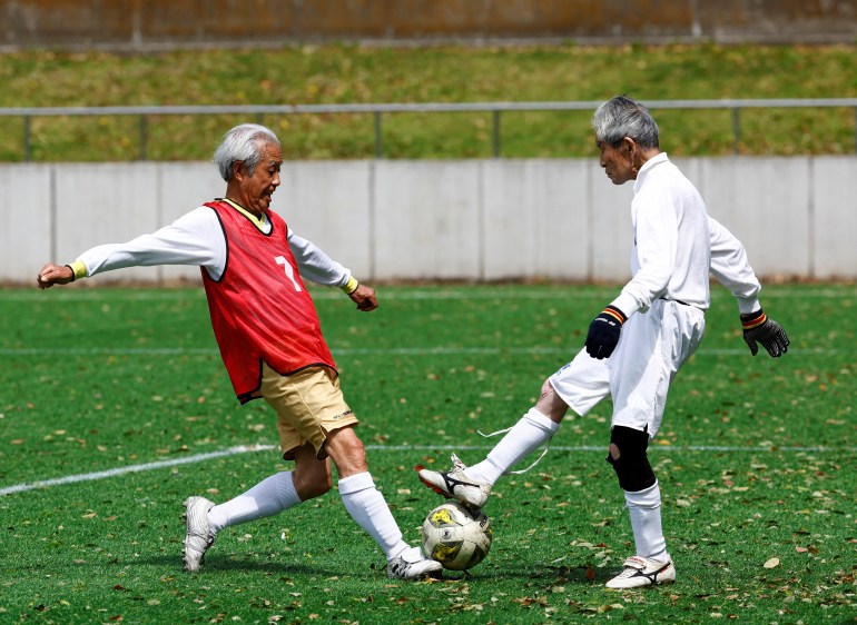 Red Star’s midfielder Mutsuhiko Nomura (left), 83, shoots to score a goal against Blue Hawai’s goalkeeper Hiroshi Nishino, 87, at the SFL (Soccer For Life) 80 League opening match in Tokyo, Japan, April 12, 2023. Nomura, who was chosen as an outstanding athlete in high school and had a place in the Japanese national team, is now a member of the inaugural soccer league, the SFL, for seniors aged 80 or older in Tokyo, with the average age between 82 and 84 in three teams, and the oldest player being 94 years old. "If possible, of course I want to keep playing until I'm 100 (years old)," Nomura said. REUTERS/Kim Kyung-Hoon SEARCH "HOON SOCCER" FOR THIS STORY. SEARCH "WIDER IMAGE" FOR ALL STORIES.