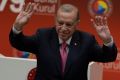 Turkish President Tayyip Erdogan greets the attendees of the annual general meeting of the Union of Chambers and Commodity Exchanges after winning Sunday's presidential election runoff in Ankara