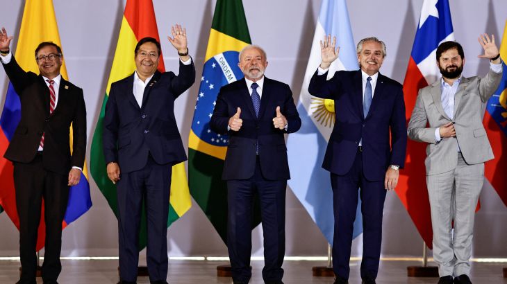 The leaders of Colombia, Bolivia, Brazil, Argentina and Chile wave during a South America summit in Brasilia